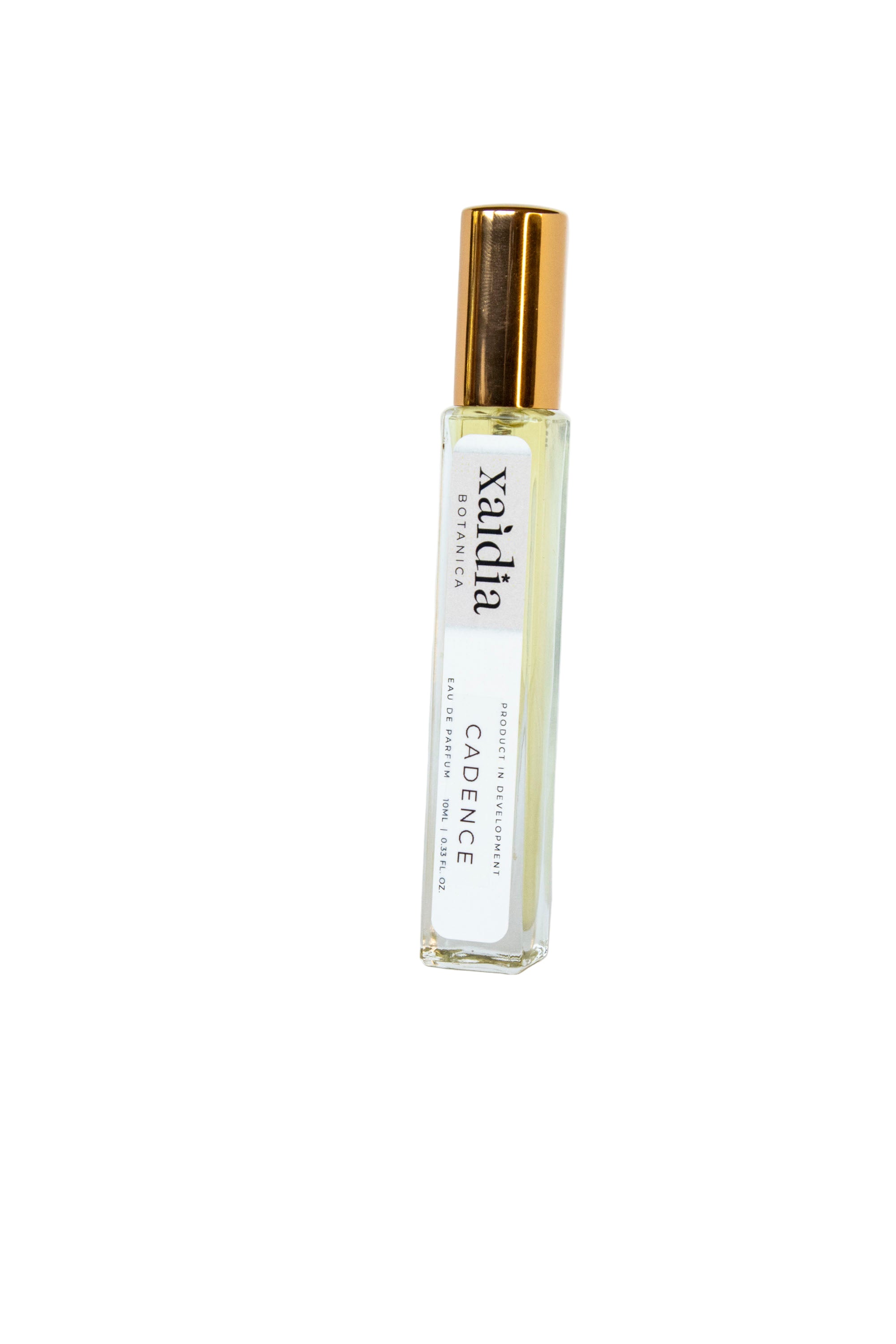 Small perfume bottle with gold cap on a white background